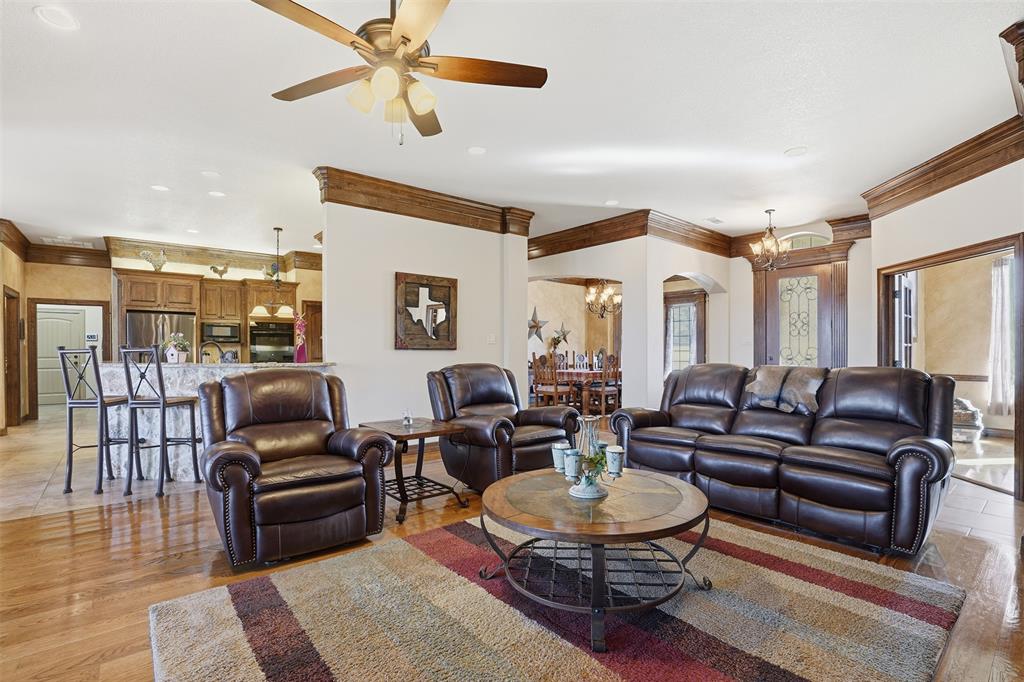 842 County Road 4371 Decatur, TX 76234 - Photo 16 of 35 a living room with furniture a rug and a chandelier