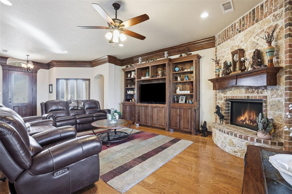 842 County Road 4371 Decatur, TX 76234 - Photo 17 of 35 a living room with furniture a flat screen tv and a fireplace