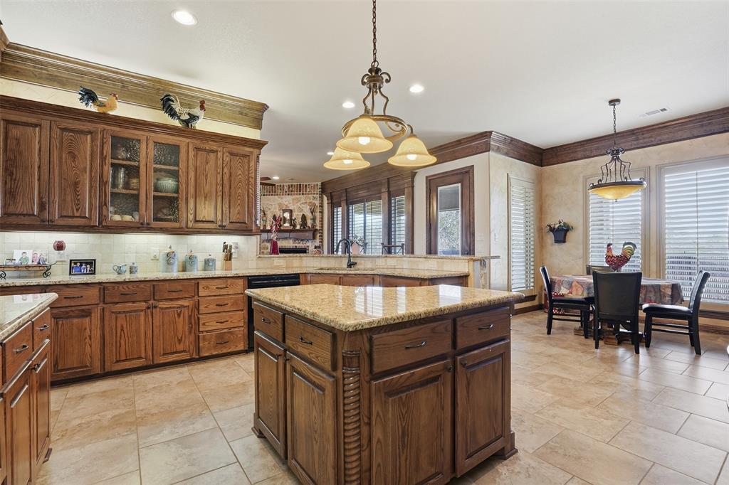 842 County Road 4371 Decatur, TX 76234 - Photo 19 of 35 a kitchen with granite countertop a sink and cabinets