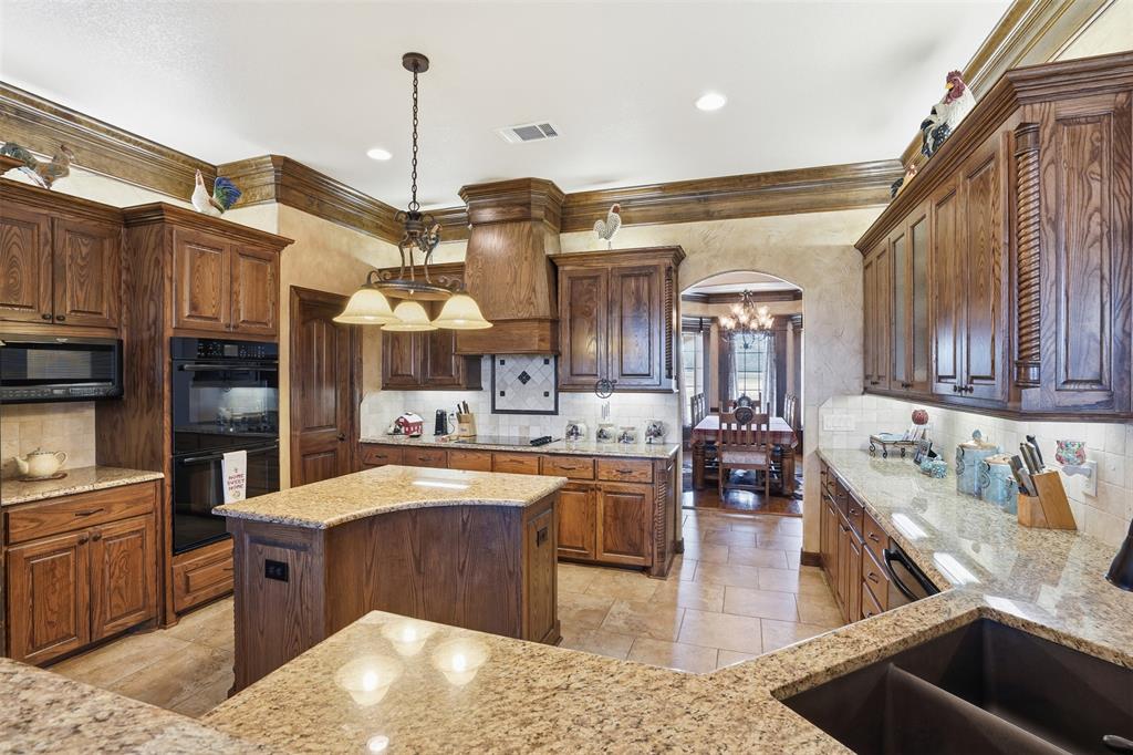 842 County Road 4371 Decatur, TX 76234 - Photo 21 of 35 a kitchen with stainless steel appliances granite countertop a sink stove and cabinets