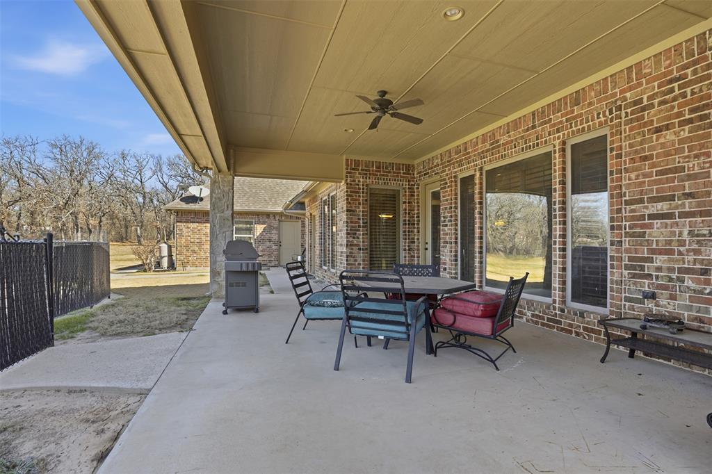 842 County Road 4371 Decatur, TX 76234 - Photo 25 of 35 a living room with furniture and a floor to ceiling window