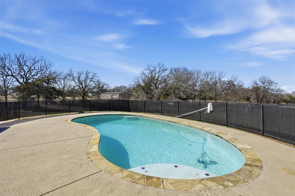 842 County Road 4371 Decatur, TX 76234 - Photo 26 of 35 a view of a swimming pool with a yard