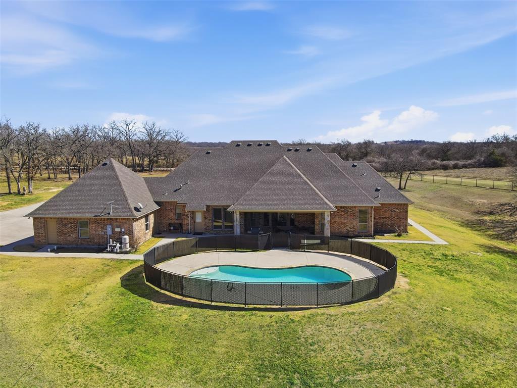 842 County Road 4371 Decatur, TX 76234 - Photo 32 of 35 a view of a white house with a swimming pool and a yard