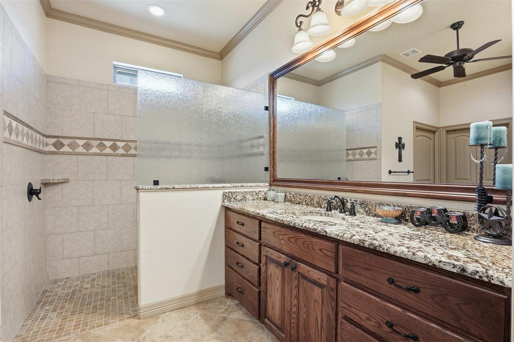 842 County Road 4371 Decatur, TX 76234 - Photo 5 of 35 a bathroom with a granite countertop sink a mirror and a shower
