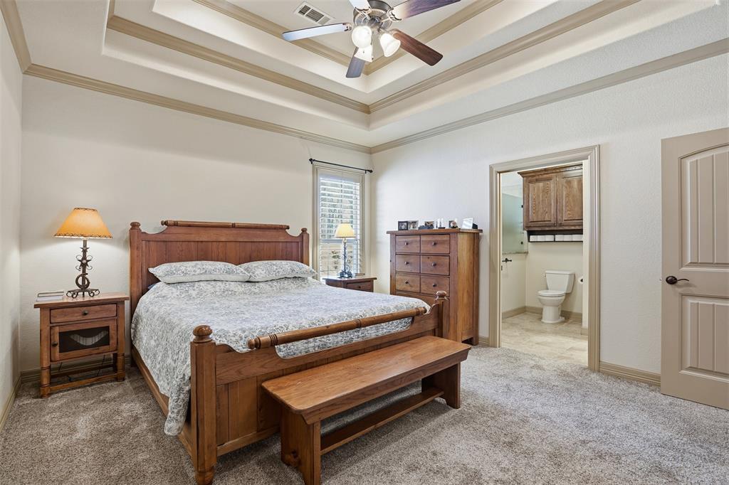 842 County Road 4371 Decatur, TX 76234 - Photo 10 of 35 a bedroom with a bed and a chandelier