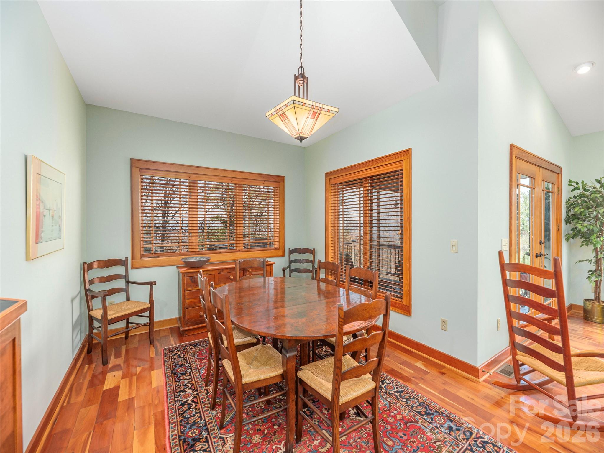68 Crestwood Road Asheville, NC 28804 - Photo 12 of 37 a view of a dining room with furniture wooden floor and a chandelier