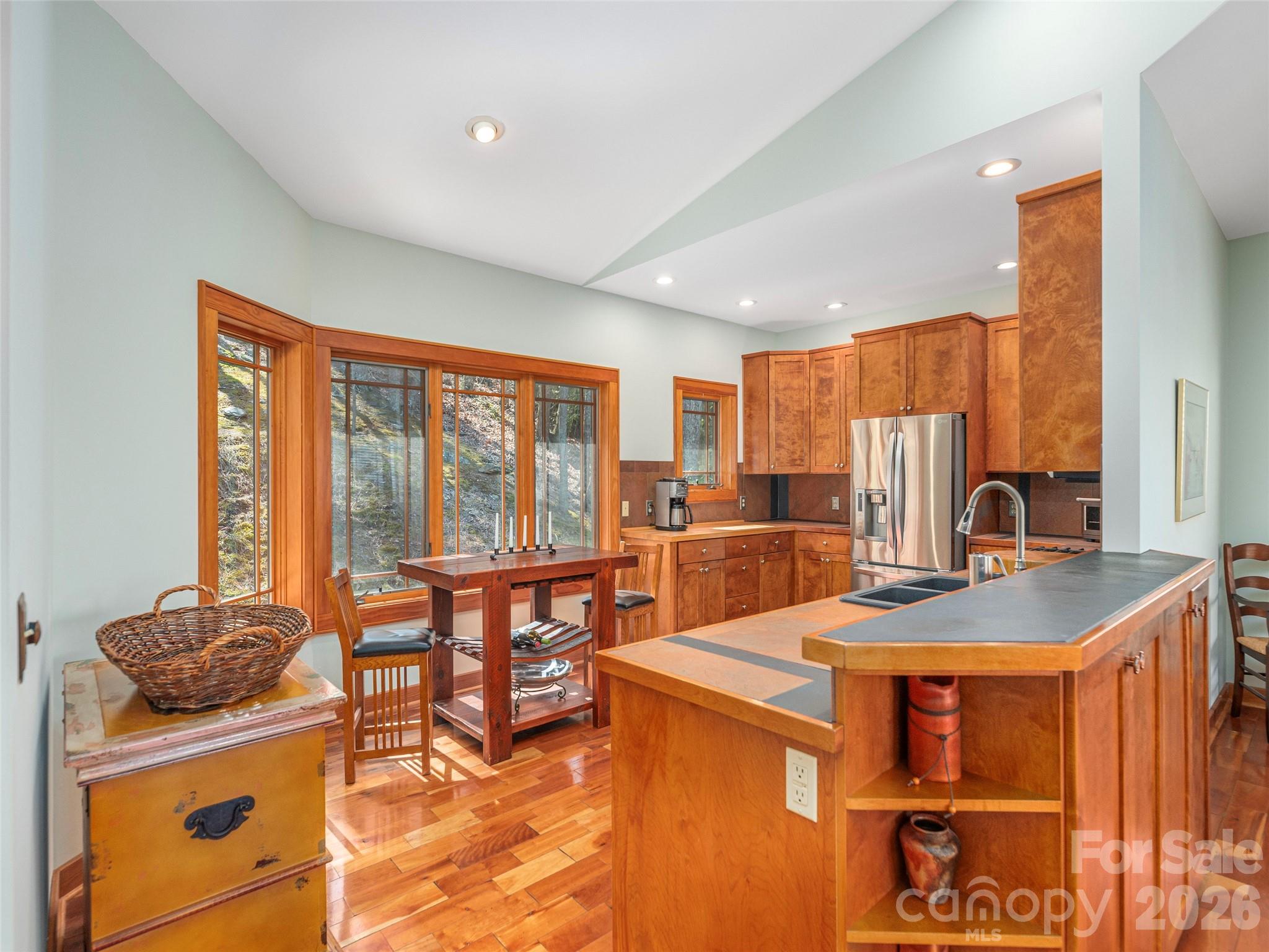 68 Crestwood Road Asheville, NC 28804 - Photo 13 of 37 a view of a kitchen with kitchen island a large window cabinets a sink and stainless steel appliances