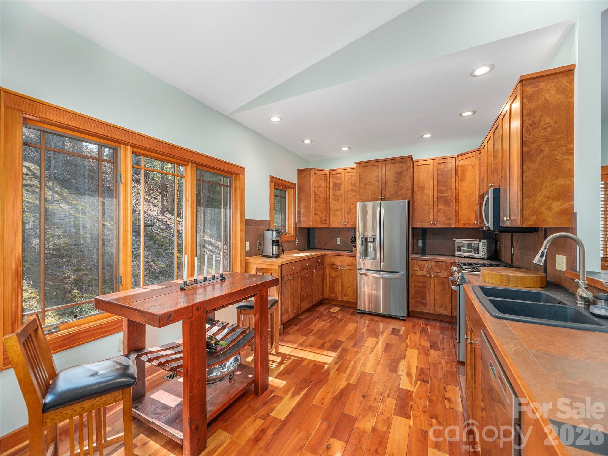 68 Crestwood Road Asheville, NC 28804 - Photo 14 of 37 a large kitchen with a large window and stainless steel appliances
