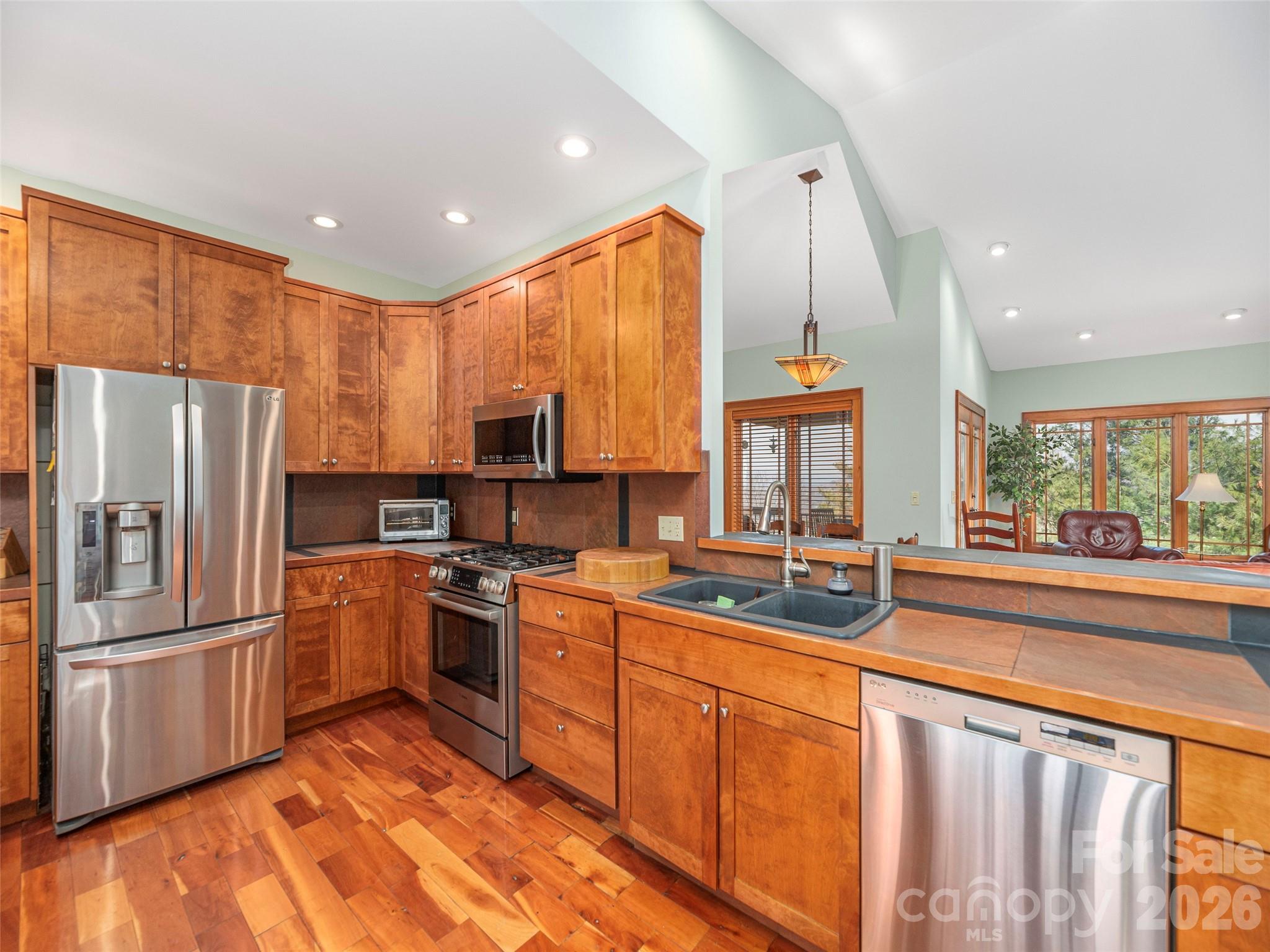 68 Crestwood Road Asheville, NC 28804 - Photo 15 of 37 a kitchen with stainless steel appliances granite countertop a refrigerator a stove top oven a sink and dishwasher