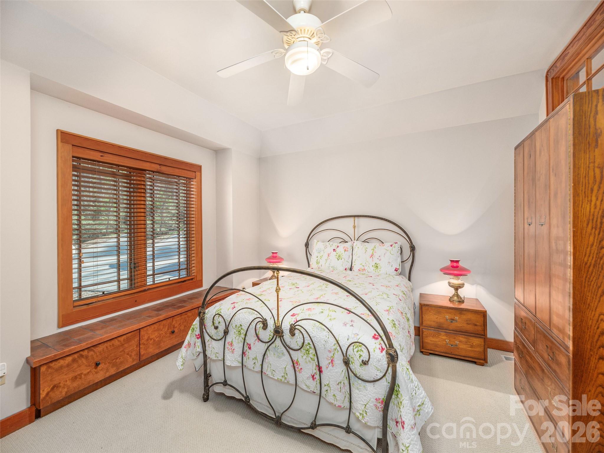 68 Crestwood Road Asheville, NC 28804 - Photo 22 of 37 a bedroom with bed and a chandelier