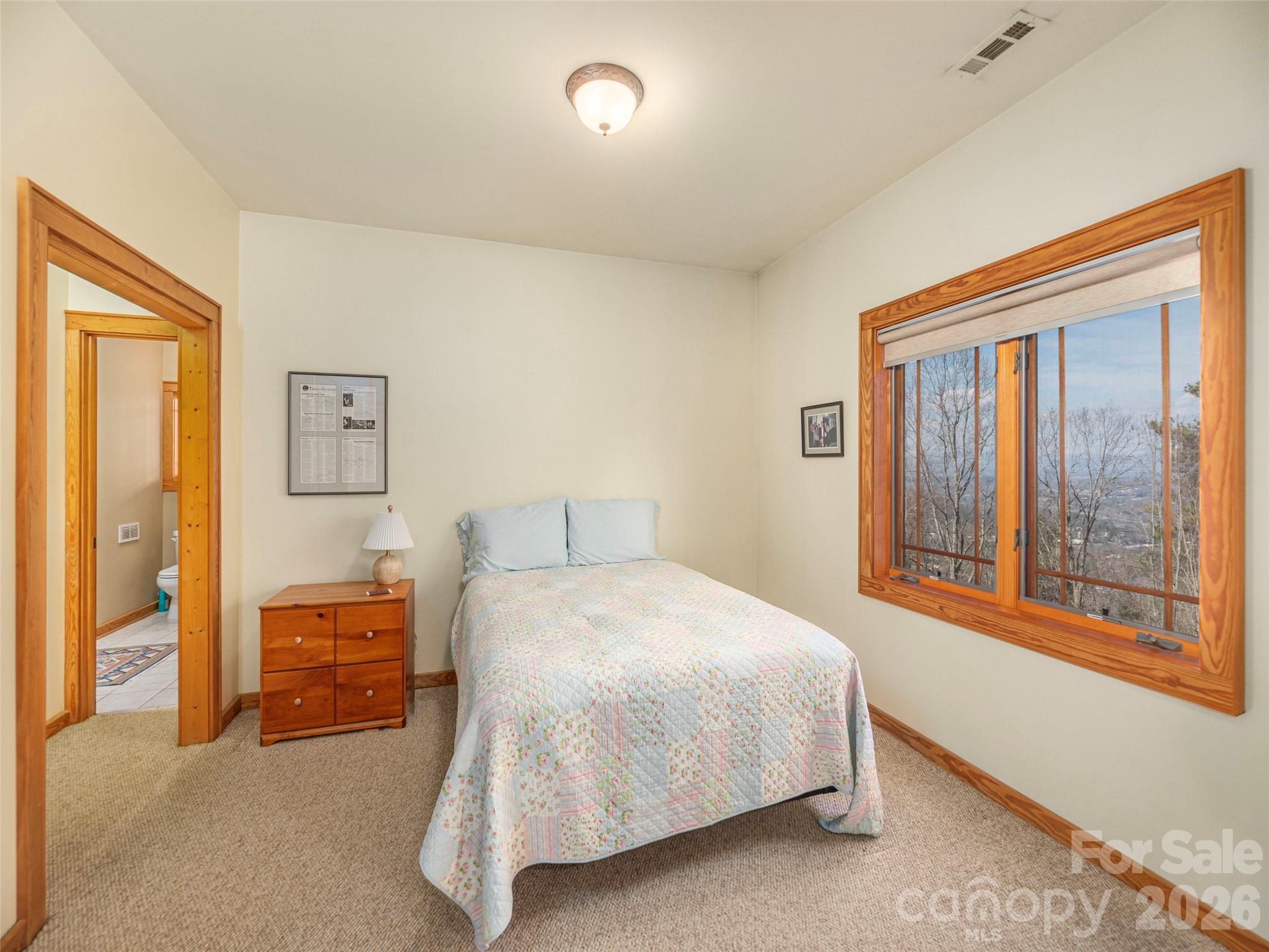 68 Crestwood Road Asheville, NC 28804 - Photo 28 of 37 a bedroom with a bed and a painting on the wall