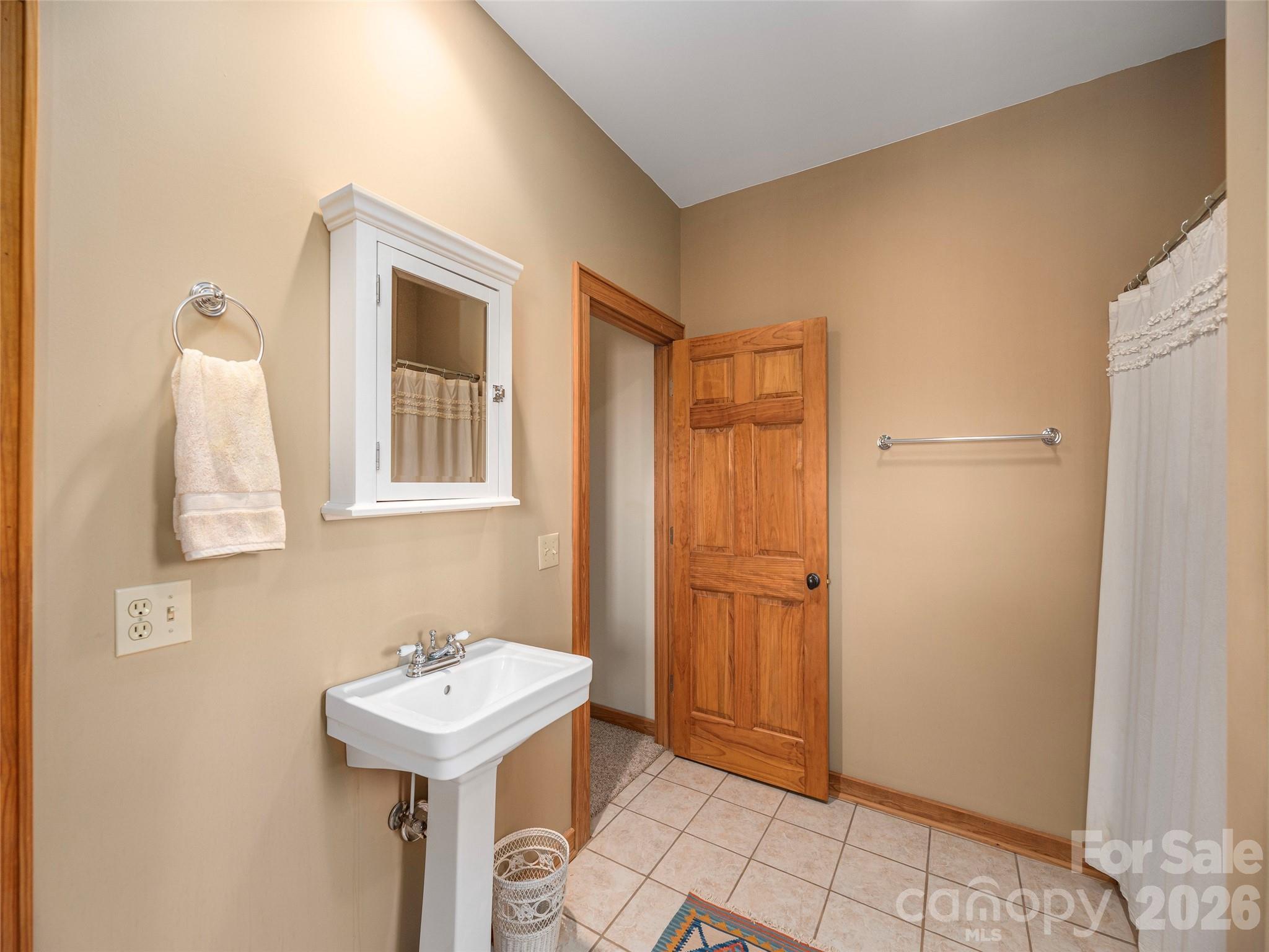 68 Crestwood Road Asheville, NC 28804 - Photo 30 of 37 a bathroom with a sink a toilet and mirror