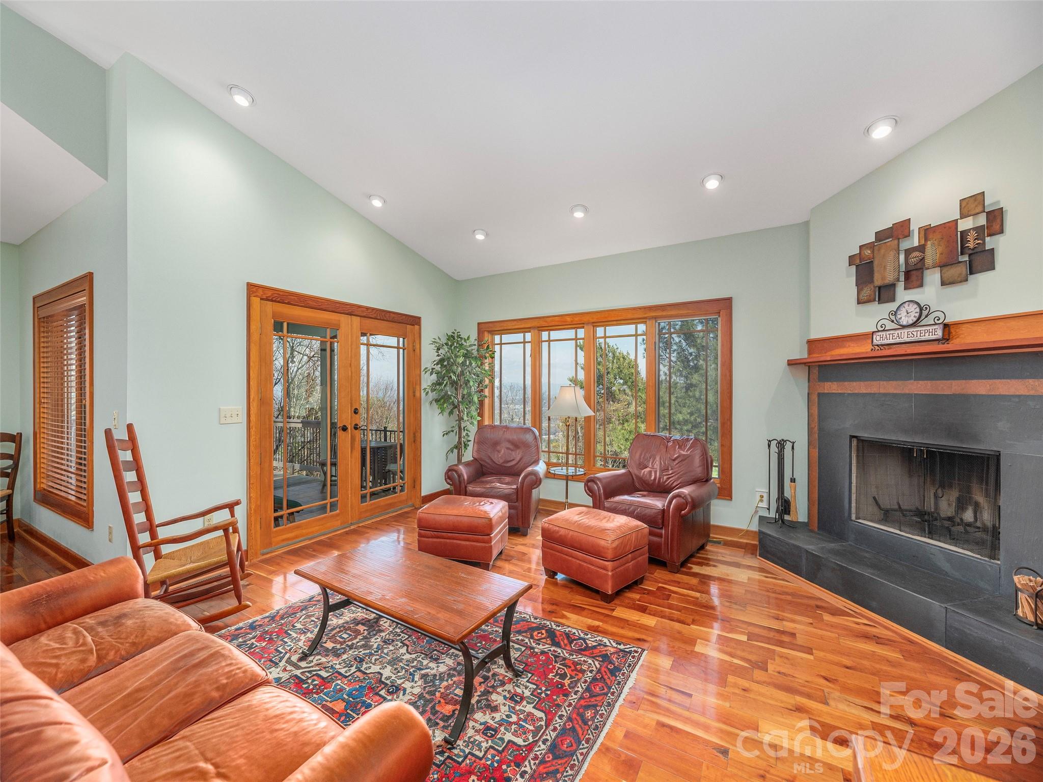 68 Crestwood Road Asheville, NC 28804 - Photo 6 of 37 a living room with furniture a fireplace and a large window