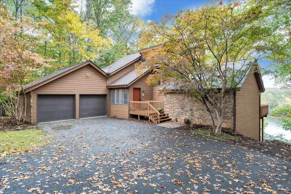 a view of a house with a yard and garage
