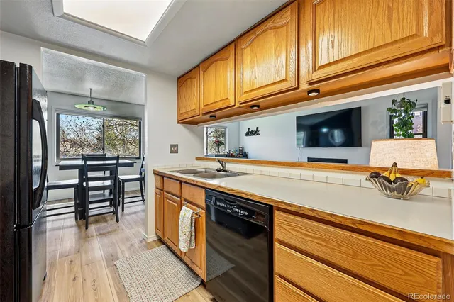 a kitchen with stainless steel appliances granite countertop a sink and a stove