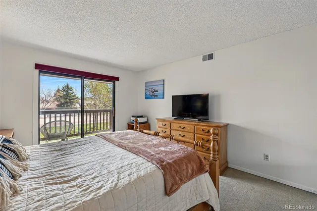 a bedroom with a bed and a television