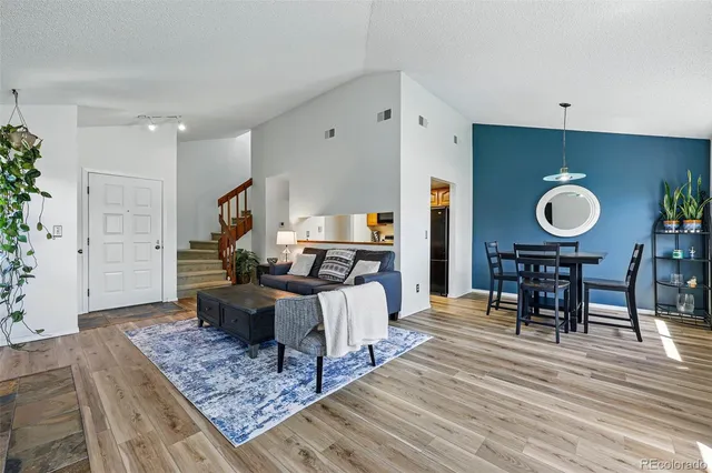 a living room with furniture and wooden floor