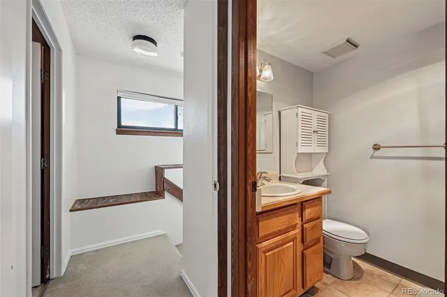 a bathroom with a toilet a sink and a mirror