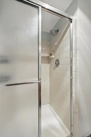a bathroom with a glass shower door