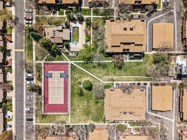 an aerial view of residential houses with outdoor space and street view