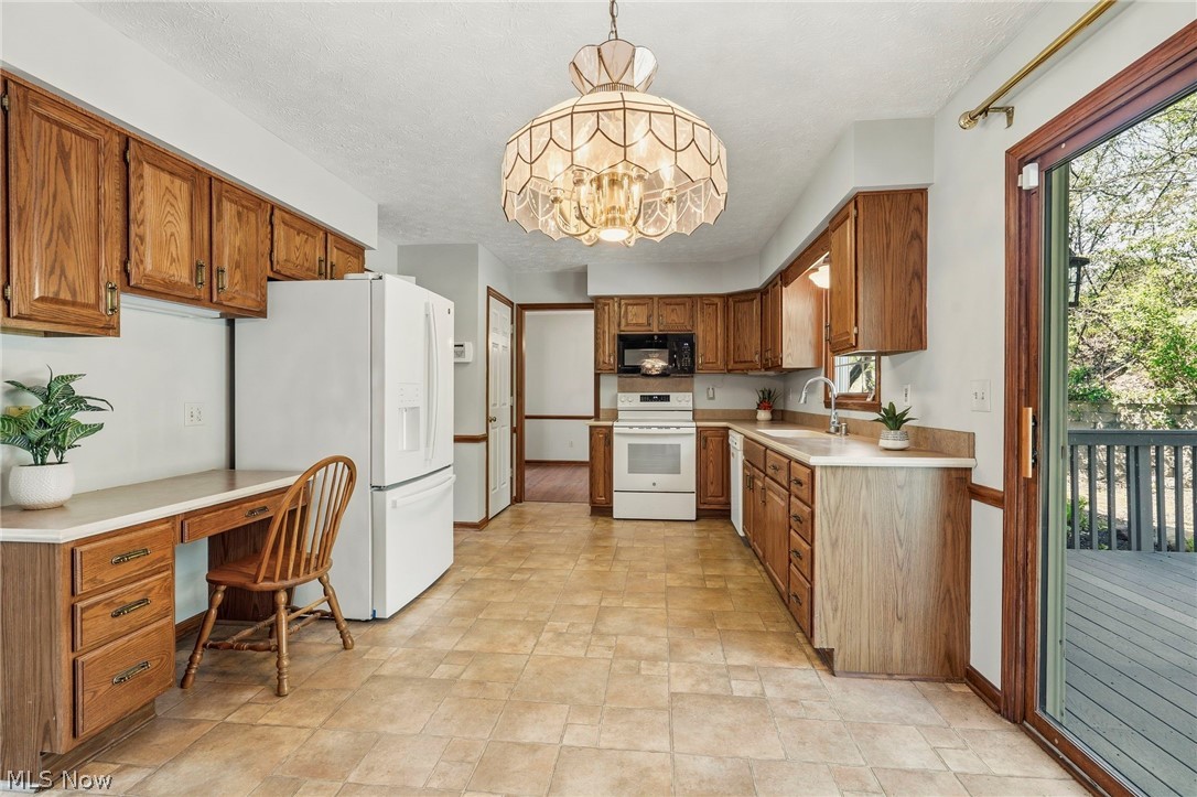 5347 Ashby Street Northwest Canton, OH 44708 - Photo 25 of 46 Kitchen with built in desk, fully applianced and door to deck