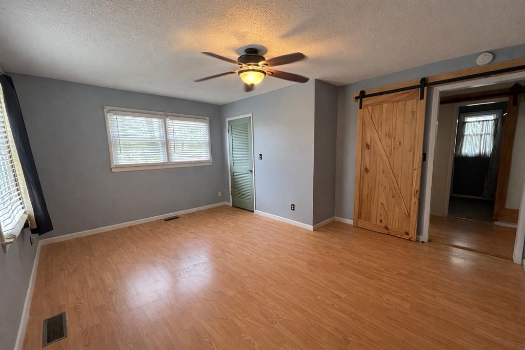 2633 Spencer Road Rock Island, TN 38581 - Photo 13 of 37 an empty room with wooden floor and windows