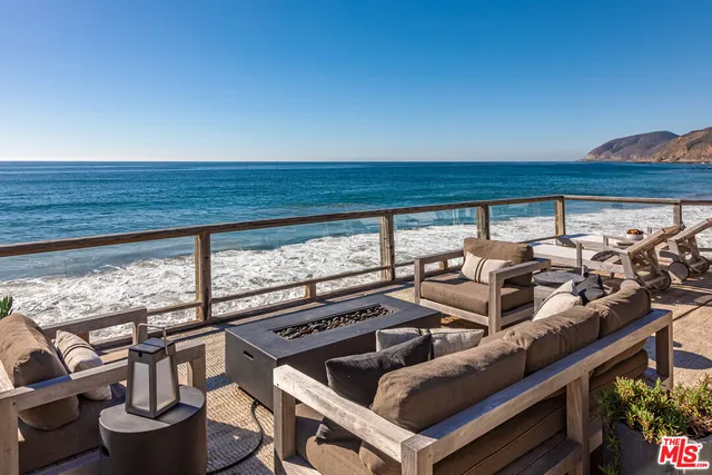 a living room with fireplace furniture and a floor to ceiling window