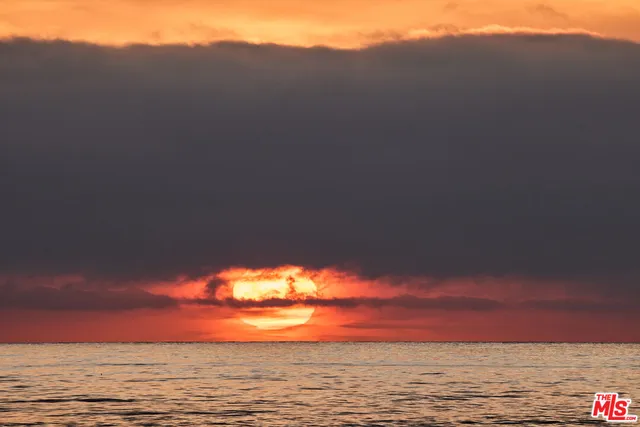 a view of ocean with sunset