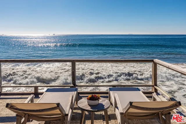 a living room with furniture and a painting on the wall