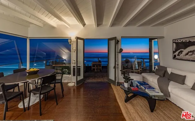 a living room with furniture a wooden floor and a fireplace