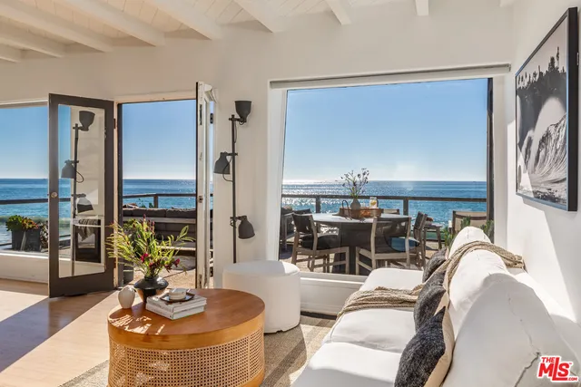 a bedroom with a bed and a flat tv screen next to a window