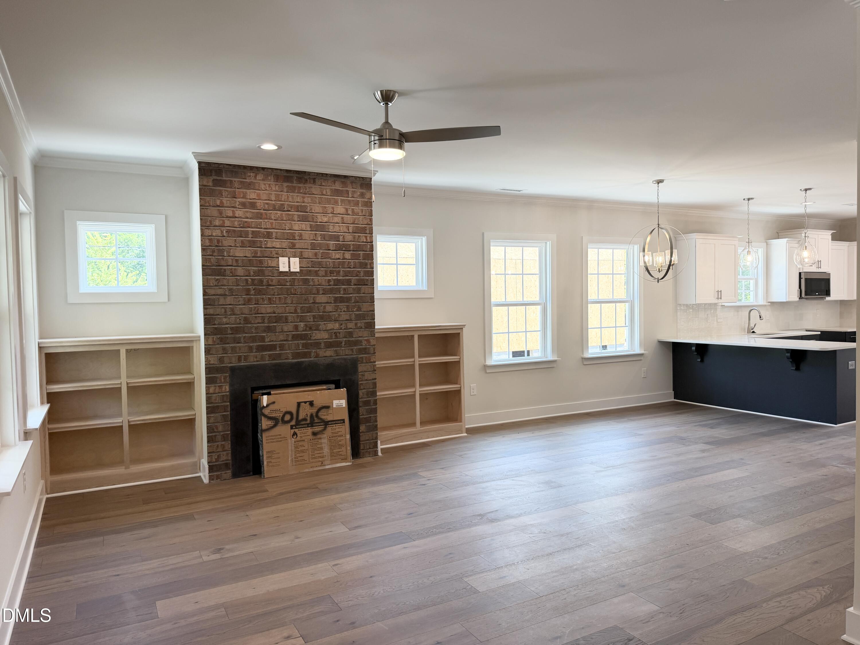 1122 Berkeley Street Durham, NC 27705 - Photo 5 of 29 an empty room with a fireplace and windows