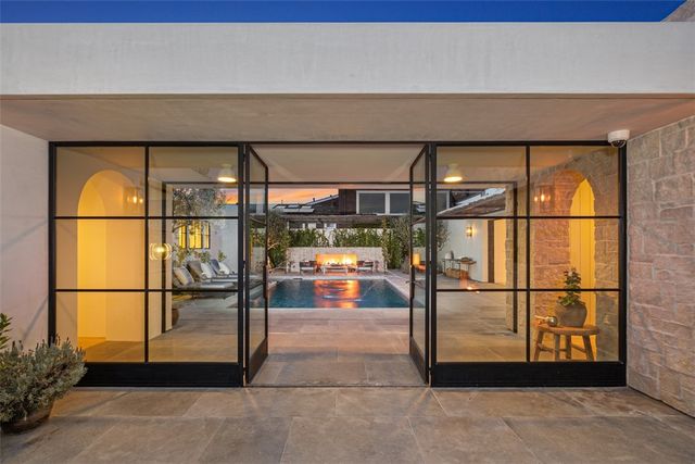 a kitchen with stainless steel appliances granite countertop a sink a stove and a wooden floors