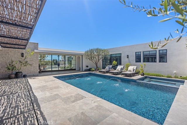 a living room with patio furniture and a floor to ceiling window