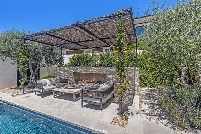 a living room with furniture a table and a large window