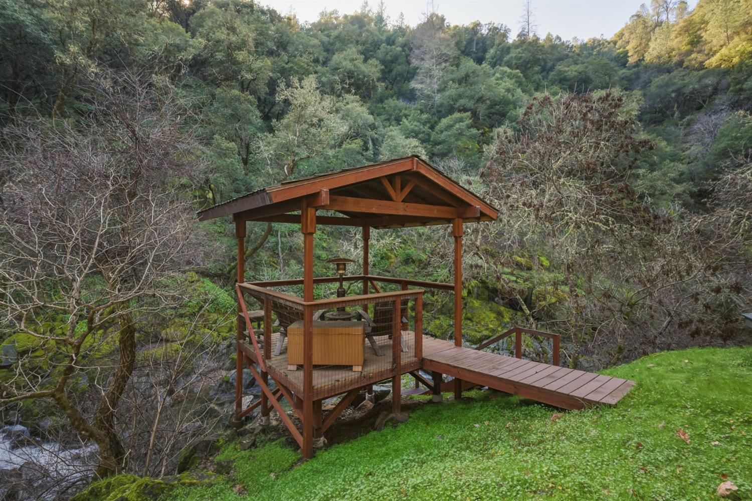 11 Upton Road Mount Aukum, CA 95656 - Photo 3 of 30 a view of a wooden deck with a bench in a forest