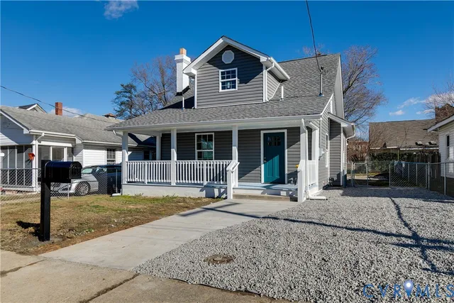 a front view of a house with a yard outdoor seating and garage