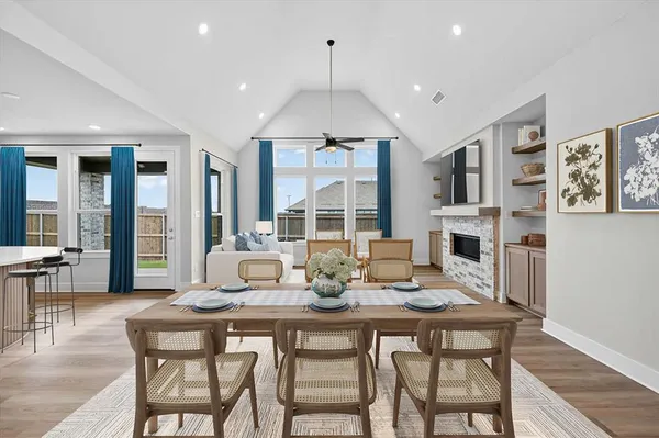 a dining room with furniture a chandelier and wooden floor