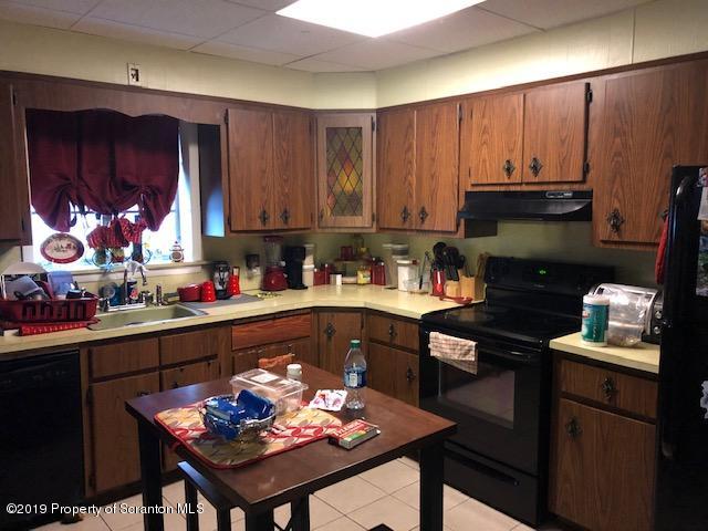 408 Main Street Moosic, PA 18507 - Photo 5 of 6 a kitchen with a cabinets appliances and a dining table