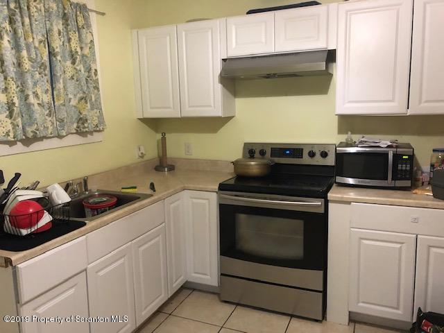 408 Main Street Moosic, PA 18507 - Photo 6 of 6 a kitchen with cabinets and appliances