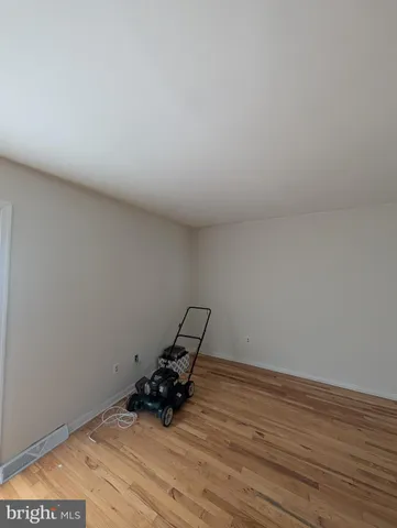 a room with wooden floor and bench