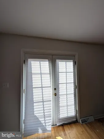 a view of a livingroom with an empty space and a window