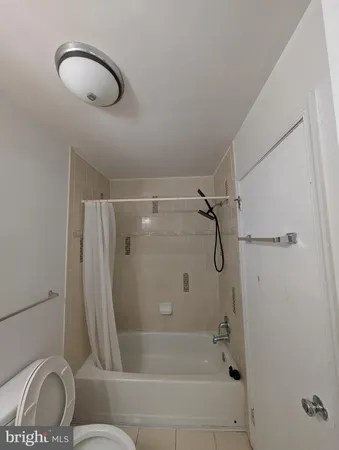 a bathroom with a shower and a toilet