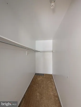 an empty room with a window and a fireplace