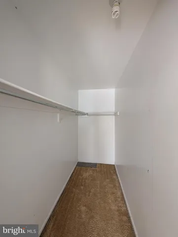 an empty room with a window and a fireplace