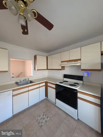 a kitchen with stainless steel appliances granite countertop a sink and dishwasher a stove top oven with wooden floor