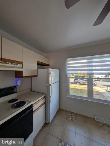 a kitchen with a stove and a refrigerator