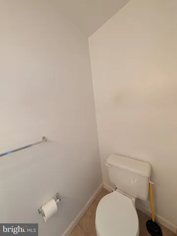 a white toilet sitting next to a shower