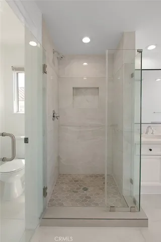 a bathroom with a shower and toilet