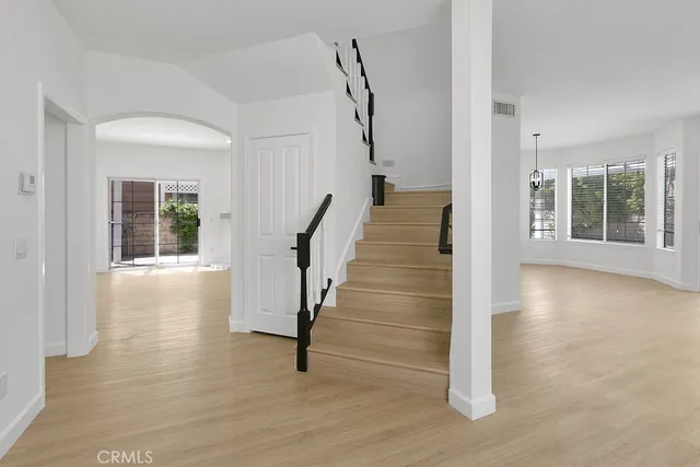 a view of entryway with wooden floor and stairs